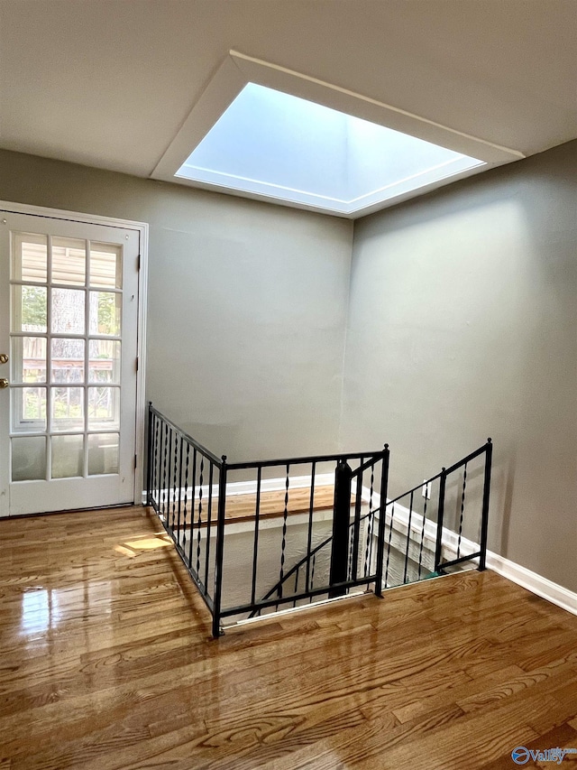 stairs with baseboards and wood finished floors