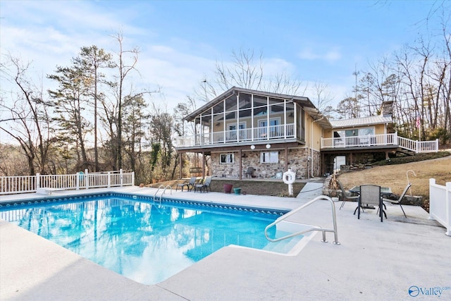 view of pool with a patio area and a sunroom