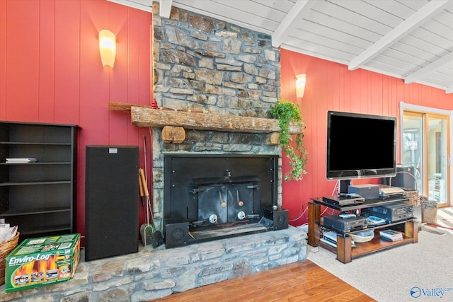 carpeted living room with a fireplace, beam ceiling, wooden ceiling, and wood walls