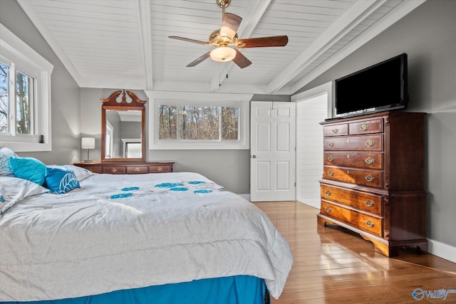 bedroom featuring ceiling fan, light hardwood / wood-style flooring, lofted ceiling with beams, and wooden ceiling