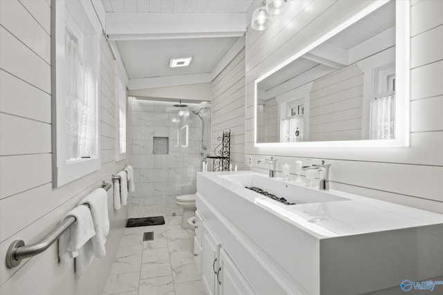 bathroom with vanity, wood walls, lofted ceiling with beams, toilet, and a tile shower