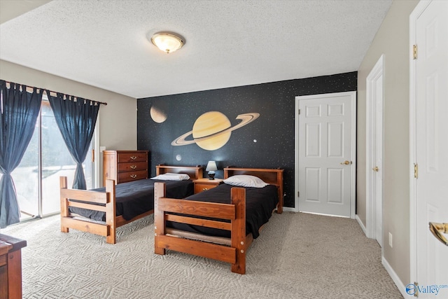 bedroom featuring a textured ceiling, access to outside, and light colored carpet