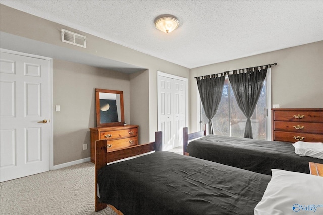 bedroom with carpet flooring, a closet, and a textured ceiling