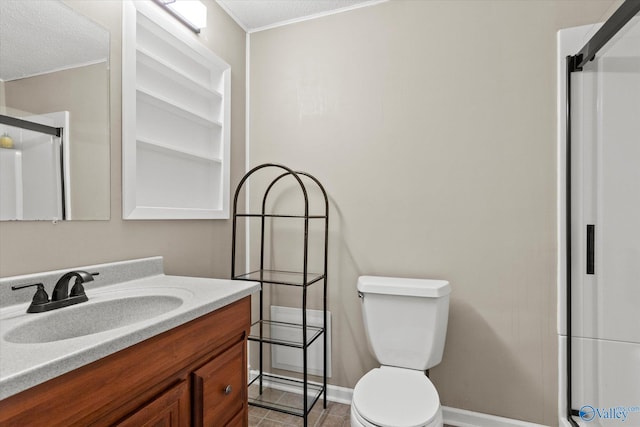 bathroom featuring a shower with door, vanity, and toilet