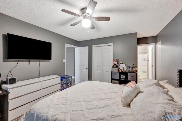 bedroom featuring ensuite bath, ceiling fan, a closet, and a textured ceiling