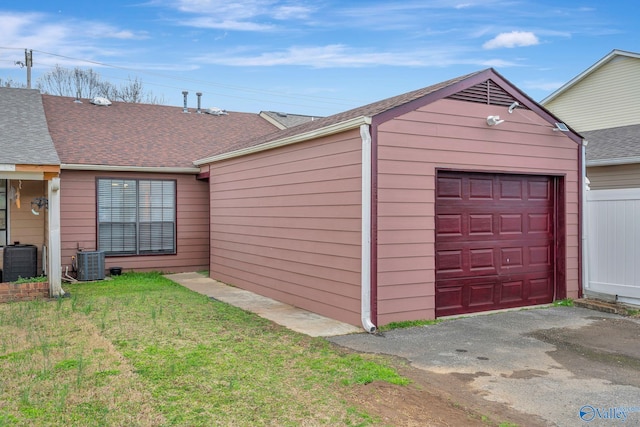 garage featuring cooling unit and driveway