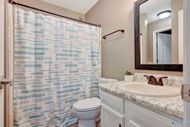 bathroom featuring a textured ceiling, toilet, and vanity