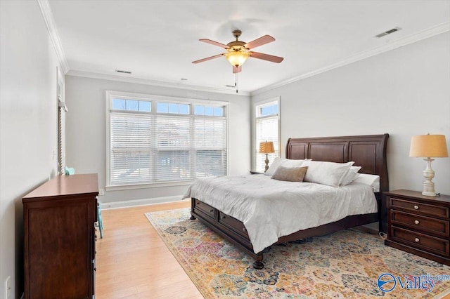 bedroom with a ceiling fan, visible vents, baseboards, ornamental molding, and light wood finished floors