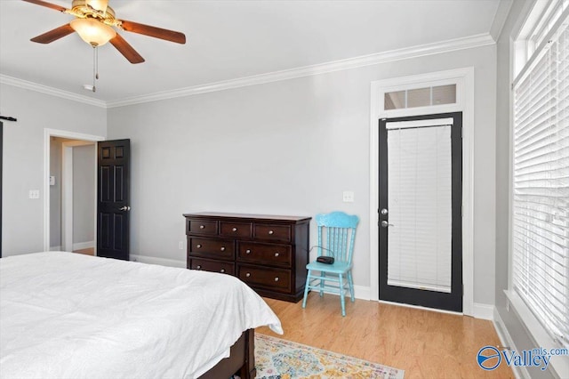 bedroom with a ceiling fan, crown molding, baseboards, and wood finished floors