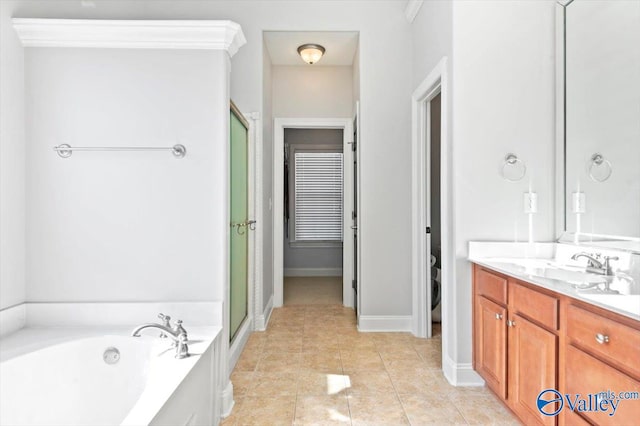 full bathroom with a garden tub, a stall shower, vanity, baseboards, and tile patterned floors