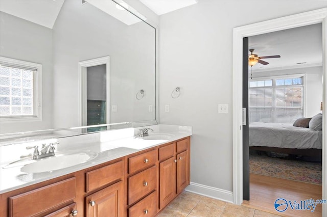 ensuite bathroom featuring double vanity, ensuite bath, tile patterned flooring, and a sink