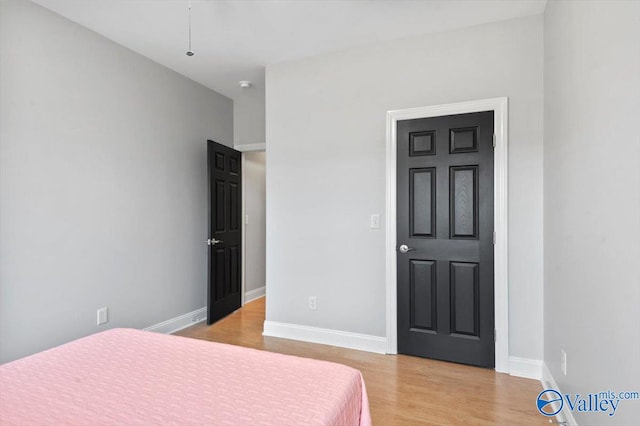 bedroom featuring light wood-type flooring and baseboards