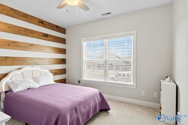 carpeted bedroom with baseboards, visible vents, and ceiling fan