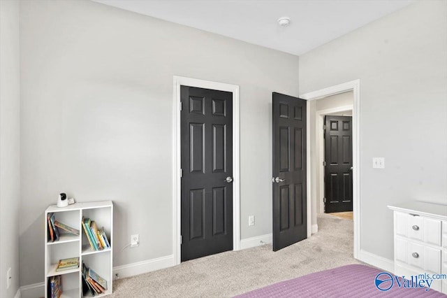 carpeted bedroom featuring baseboards