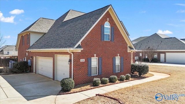 view of side of home with a garage, brick siding, driveway, and roof with shingles