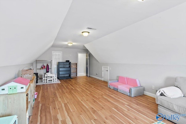 game room featuring lofted ceiling, baseboards, visible vents, and wood finished floors