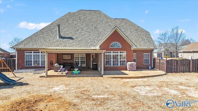 back of house with a patio, a playground, brick siding, a shingled roof, and fence