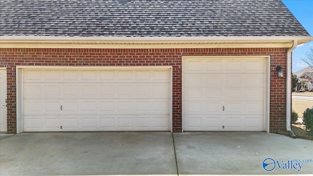 garage featuring concrete driveway