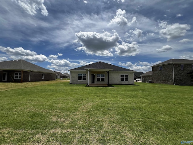 back of property featuring a yard