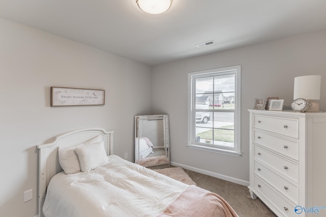 bedroom featuring light carpet