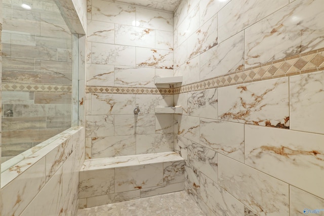 bathroom featuring tiled shower