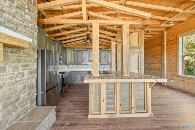 kitchen featuring wood walls, dark hardwood / wood-style flooring, lofted ceiling with beams, and appliances with stainless steel finishes