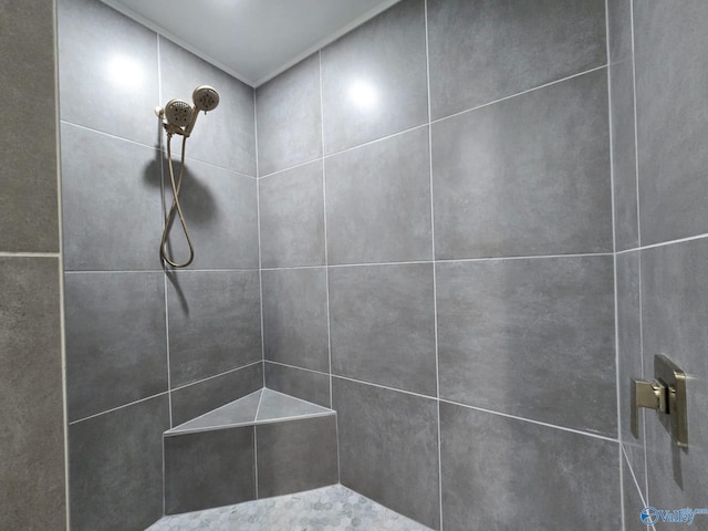 full bath with a tile shower