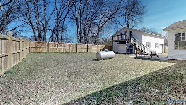 view of yard featuring stairs, a patio, and a fenced backyard