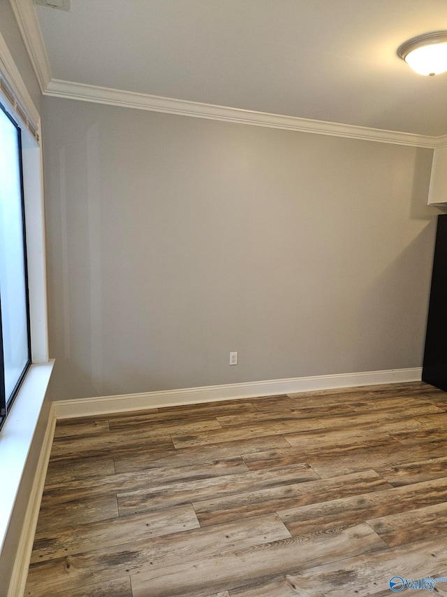 spare room with ornamental molding and hardwood / wood-style floors