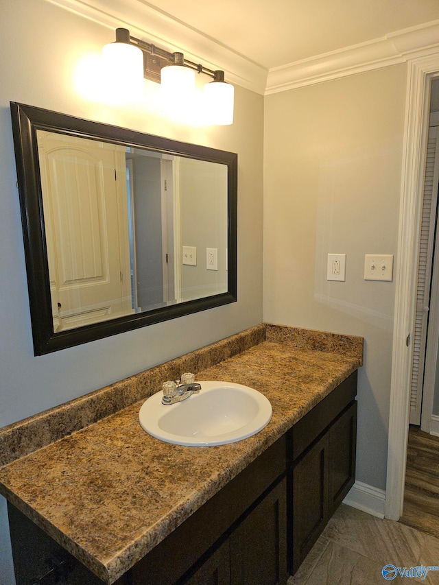 bathroom featuring ornamental molding and vanity