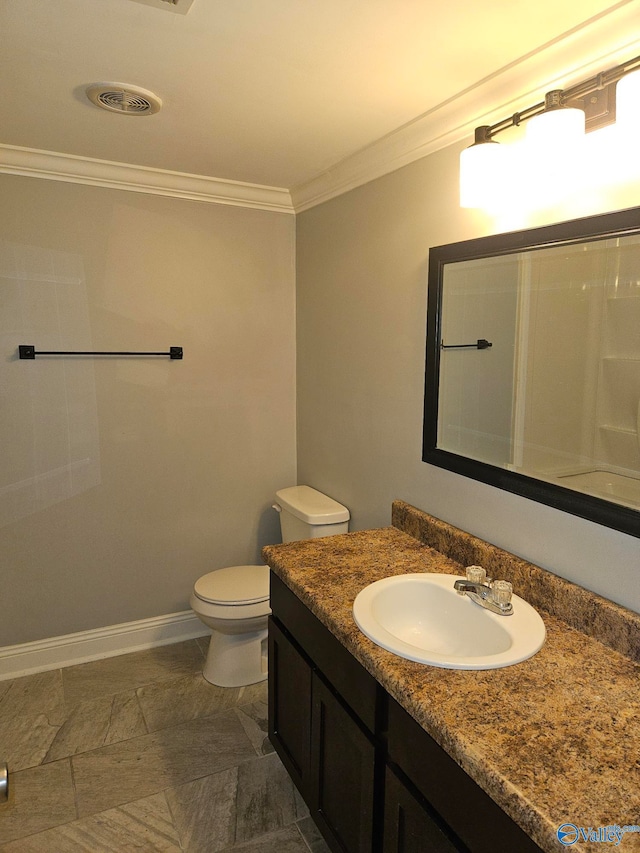 bathroom featuring vanity, crown molding, and toilet