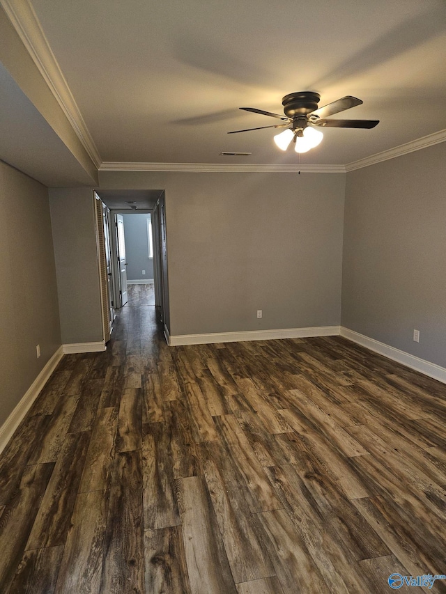 spare room featuring dark wood-type flooring, ceiling fan, and ornamental molding