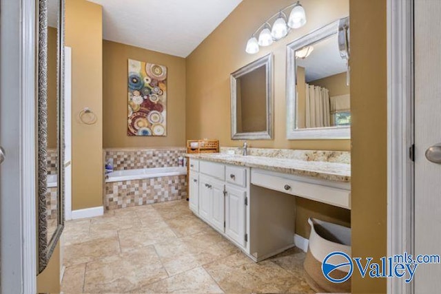 bathroom with curtained shower, a garden tub, and vanity