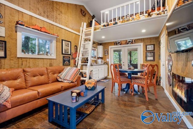 living room with wooden walls, high vaulted ceiling, wood finished floors, and french doors