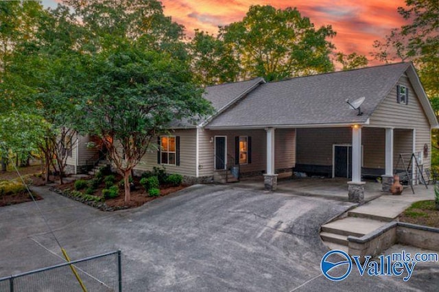 single story home with roof with shingles