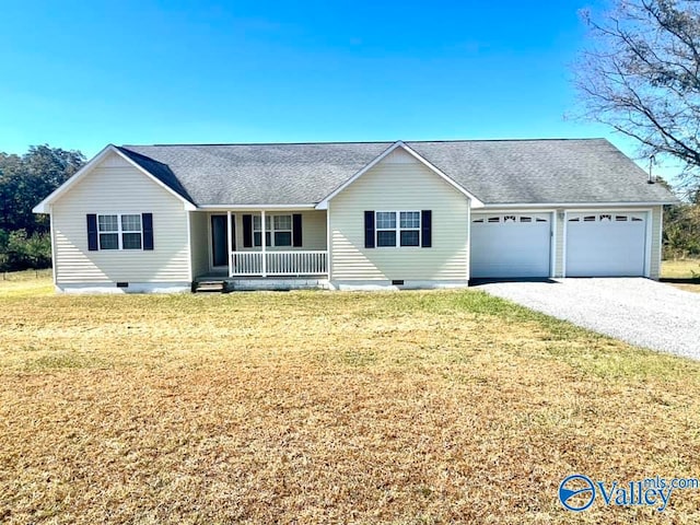 ranch-style house featuring covered porch, a garage, and a front lawn