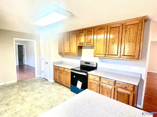 kitchen with stainless steel range with electric cooktop and light wood-type flooring