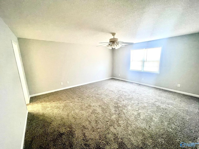 carpeted spare room with ceiling fan and a textured ceiling