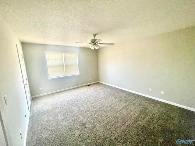 carpeted empty room featuring a textured ceiling and ceiling fan