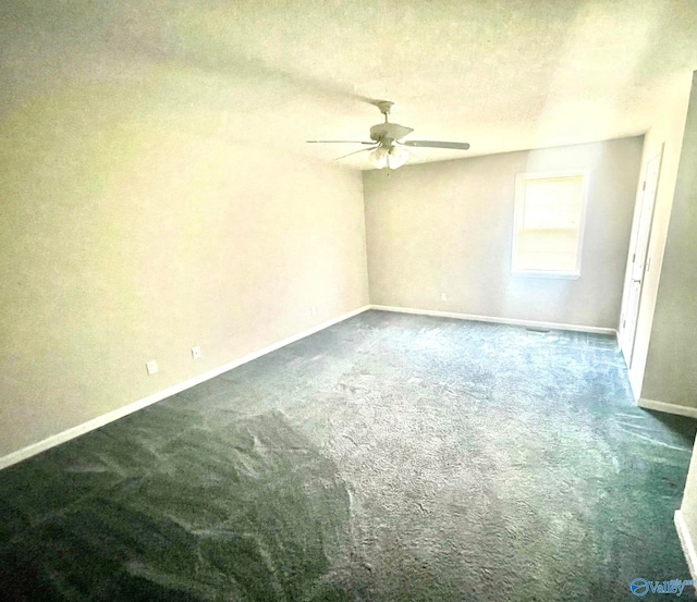 carpeted spare room featuring a textured ceiling and ceiling fan