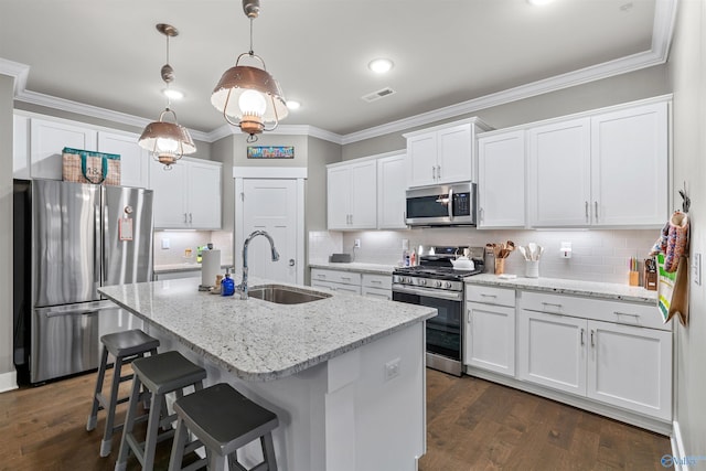 kitchen with visible vents, ornamental molding, appliances with stainless steel finishes, and a sink