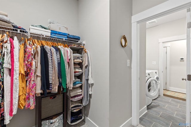 washroom with washer and dryer, visible vents, baseboards, and laundry area