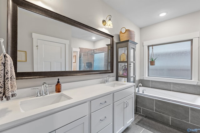 full bathroom with tile patterned flooring, a shower stall, double vanity, and a sink