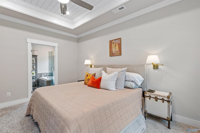 carpeted bedroom featuring visible vents, a raised ceiling, baseboards, and ornamental molding