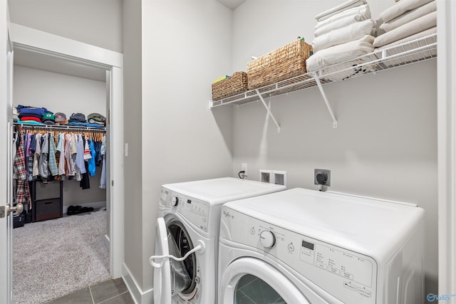 clothes washing area featuring laundry area, carpet, and washer and clothes dryer