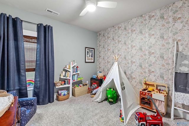 recreation room featuring wallpapered walls, visible vents, carpet floors, and ceiling fan