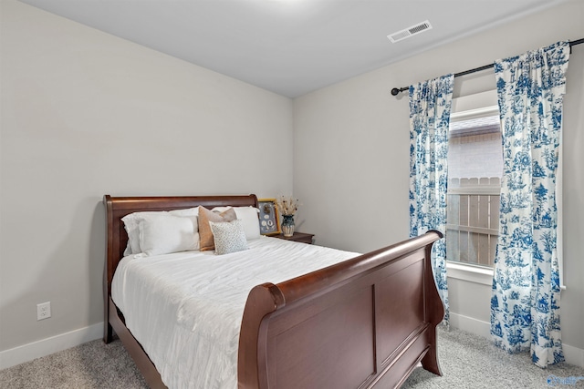 bedroom with baseboards, visible vents, and carpet floors