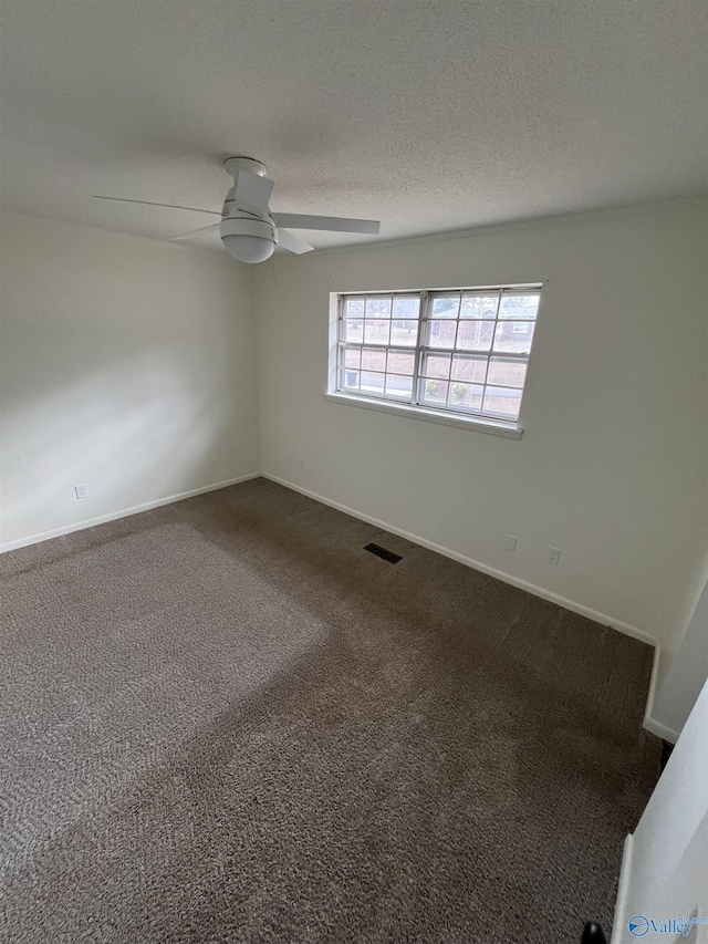 carpeted empty room featuring a textured ceiling and ceiling fan