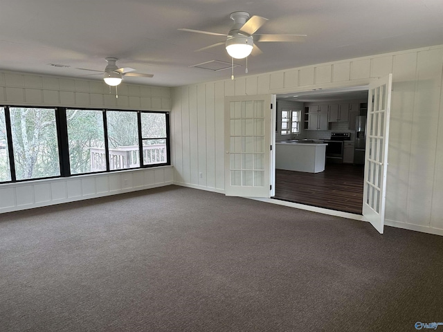 carpeted empty room featuring ceiling fan