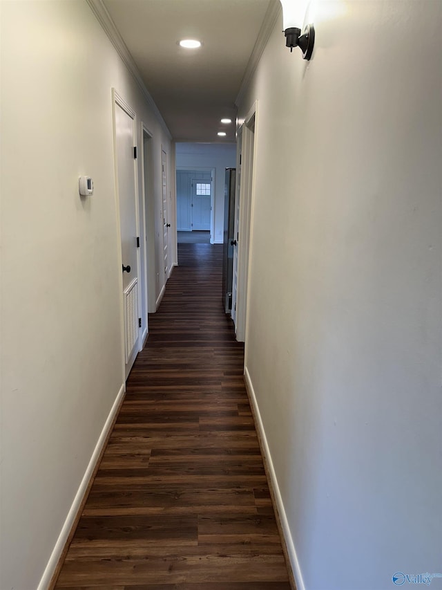 hall with dark hardwood / wood-style flooring and ornamental molding